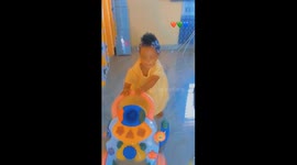 the amusement of our darling daughter, a cute baby walking on a truncheon, making her mom and dad smile