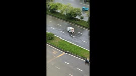 Unmanned delivery truck struggles through floodwaters during Typhoon Ragasa in Jiangsu, China
