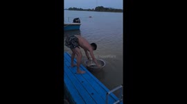 Man performs plank exercise using floating metal bowl in Guangdong, China