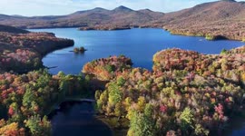 Autumn colors blanket lake from above in Vermont, USA