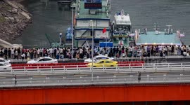 crowds gather on a bridgeto watch the amazing chongqing skyline