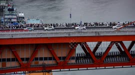 crowds gather on a bridgeto watch the amazing chongqing skyline