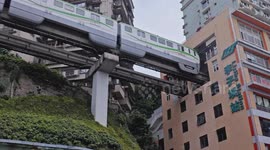 trains entering and exiting a building at liziba station in chongqing, china