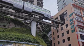 trains entering and exiting a building at liziba station in chongqing, china