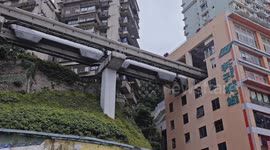 trains entering and exiting a building at liziba station in chongqing, china