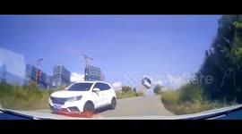Car sent 4 metres into air after losing control on slope and narrowly misses oncoming traffic