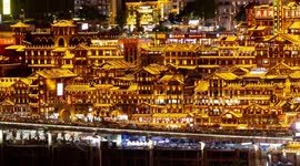 View of the amazing hongadong cave lit up at night  with the chongqing skyline in the background from a unique high vantage point