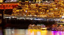 View of the amazing hongadong cave lit up at night  with the chongqing skyline in the background from a unique high vantage point