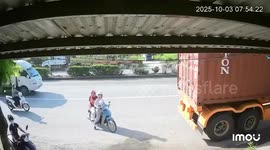 Two women on motorbike nearly crushed by reversing truck