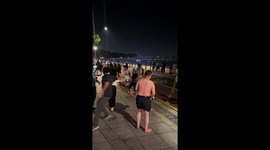 Tourists scatter as wave breaks onto promenade in China