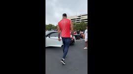At a car show, a 6’10” giant tries to fit into an Audi R8 — and instantly becomes the main attraction.