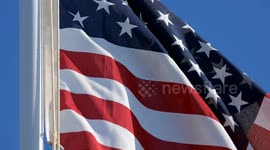 (Image 3) Flags wave at Starbase as the Starship is stacked onto Booster 15.2 prior to Flight 11