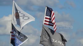 (Image 4) Flags wave at Starbase as the Starship is stacked onto Booster 15.2 prior to Flight 11