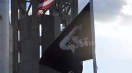 (Image 5) Flags wave at Starbase as the Starship is stacked onto Booster 15.2 prior to Flight 11