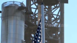 (Image 9) Flags wave at Starbase as the Starship is stacked onto Booster 15.2 prior to Flight 11