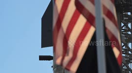 (Image 10) Flags wave at Starbase as the Starship is stacked onto Booster 15.2 prior to Flight 11