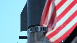 (Image 11) Flags wave at Starbase as the Starship is stacked onto Booster 15.2 prior to Flight 11