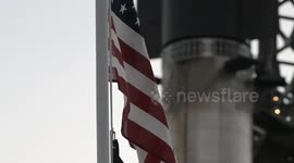(Image 12) Flags wave at Starbase as the Starship is stacked onto Booster 15.2 prior to Flight 11
