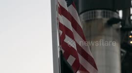 (Image 13) Flags wave at Starbase as the Starship is stacked onto Booster 15.2 prior to Flight 11