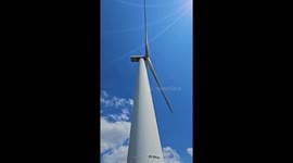 A wind turbine recorded from standing at the base in the UK. Clear blue skies