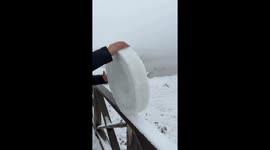 Rolling giant snow from wooden railing in Qinghai, China