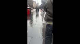 Man battles against strong wind in Edinburgh, Scotland