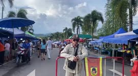 Food seller starts dancing to drum up sales to her stall at market along Thai-Cambodia border