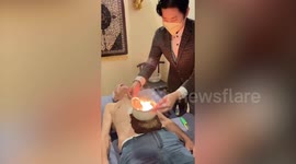 Patient has bowl of fire on tummy for gut problems