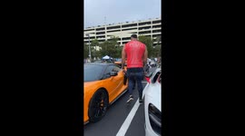 Giant 6 foot 10 bodybuilder attempts to squeeze into low McLaren
