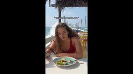 “Needs more salt”—wave crashes into diner mid-bite in viral 9 million view TikTok