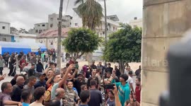 Gaza residents celebrate ceasefire announcement outside Al-Ahli hospital