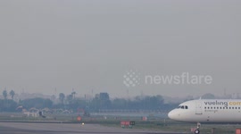 A Vueling airplane on the runway barcelona airport in spain