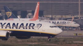 A Ryanair airplane taxiing at the terminal of barcelona airport in spain