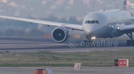 An american airlines airplane taxiing after landing at the terminal of barcelona airport in spain