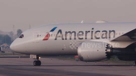 An american airlines airplane taxiing after landing at the terminal of barcelona airport in spain