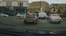 Cyclist decides to ride on the wrong side of the road across a crossing with pedestrians on it in South London