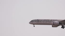 A Saudi airlines airplancoming into land at the terminal of barcelona airport in spain