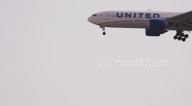 A united airlines airplane coming into land at the terminal of barcelona airport in spain