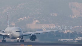 An american airlines airplane taxiing after landing at the terminal of barcelona airport in spain