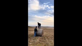 Man runs on haystack roll in Inner Mongolia, China