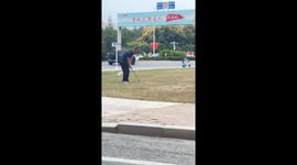Man casually plays golf by the roadside in Tianjin, China