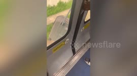 Suitcase dangles out of moving train in Paris