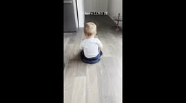Boy Riding Robot Vacuum Bumps Toes