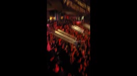 Fan Hangs Over Railing and Falls at Metal Concert