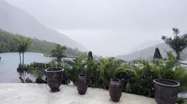 rainy day at a tropical resort in amed, bali with raindrops falling into the pool