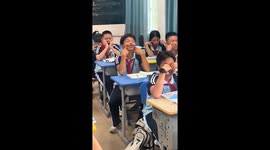 Students perform funny face and head exercises in Hainan classroom, China