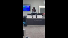 Tense scene at airport after passenger failed attempt to attack airline employee, jumps counter and throws hairpins and verbally attack bystanders.