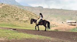 Woman startled as horse suddenly rolls on the ground in Xinjiang, China