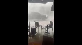 Restaurant tables blown over as storm whips through street in Malaysia