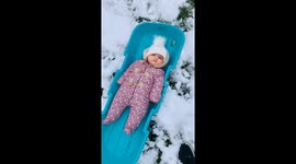 Parents shocked as 1-year-old girl is not amused with sledding
